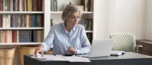 A woman reviewing and calculating taxes