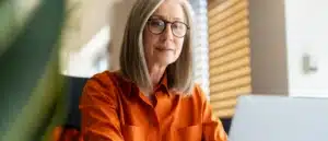 A woman working on her taxes on a computer