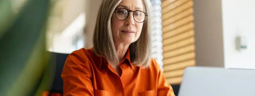 A woman working on her taxes on a computer
