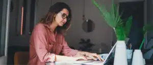 A woman working on a computer to remove a lien