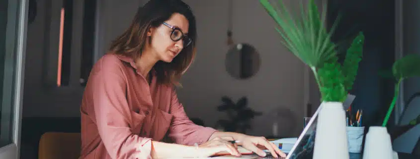 A woman working on a computer to remove a lien