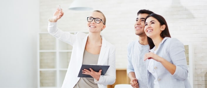 A couple looking at a property with a realtor