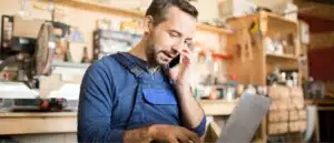 A business owner on the phone while reviewing his accounts