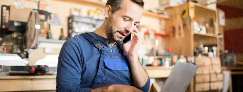 A business owner on the phone while reviewing his accounts