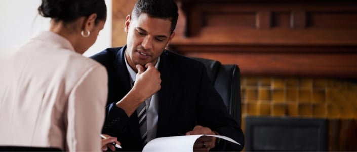 A person reviewing tax paperwork with a professional