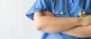 A close-up of the folded arms of a medical professional